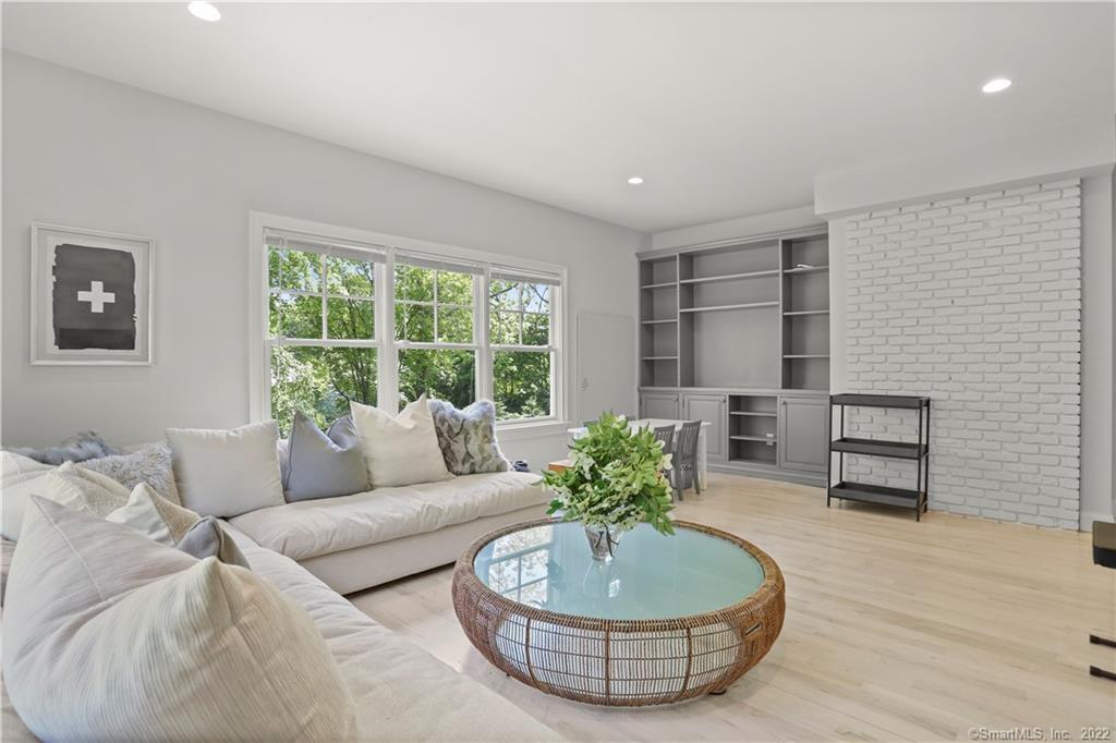 220 Burr Street Fairfield, CT 06824 - Photo 11 of 34 a living room with furniture and a potted plant