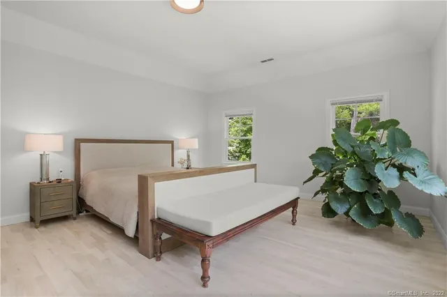 a bed sitting in a bedroom next to a window