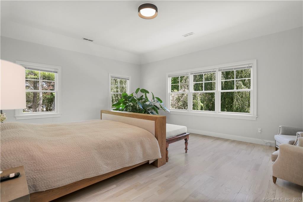 220 Burr Street Fairfield, CT 06824 - Photo 15 of 34 a bed sitting in a bedroom next to a window