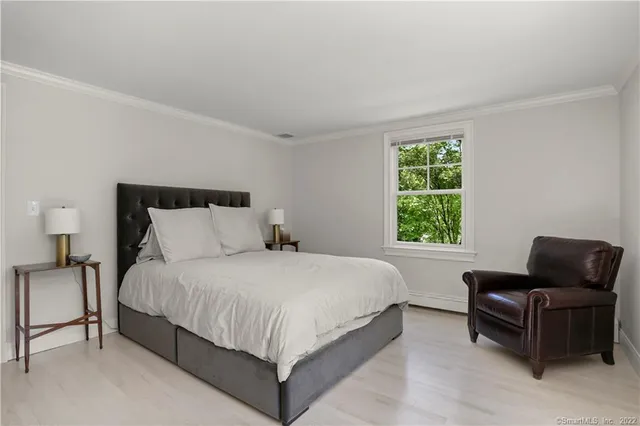 a bedroom with bed and window