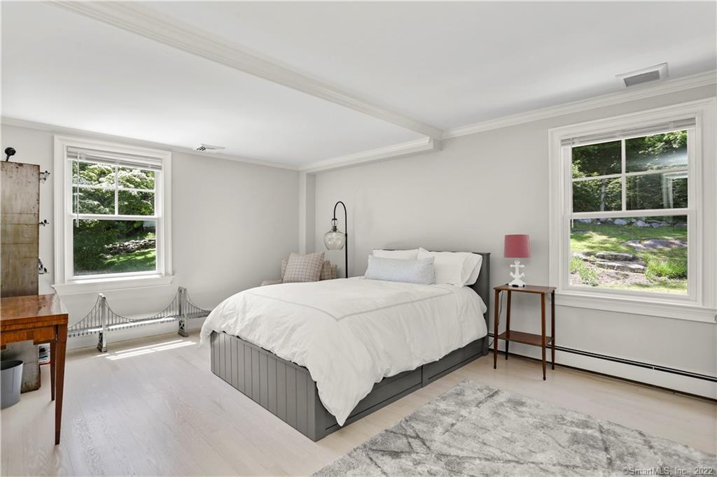 220 Burr Street Fairfield, CT 06824 - Photo 22 of 34 a bedroom with a bed chair and a window