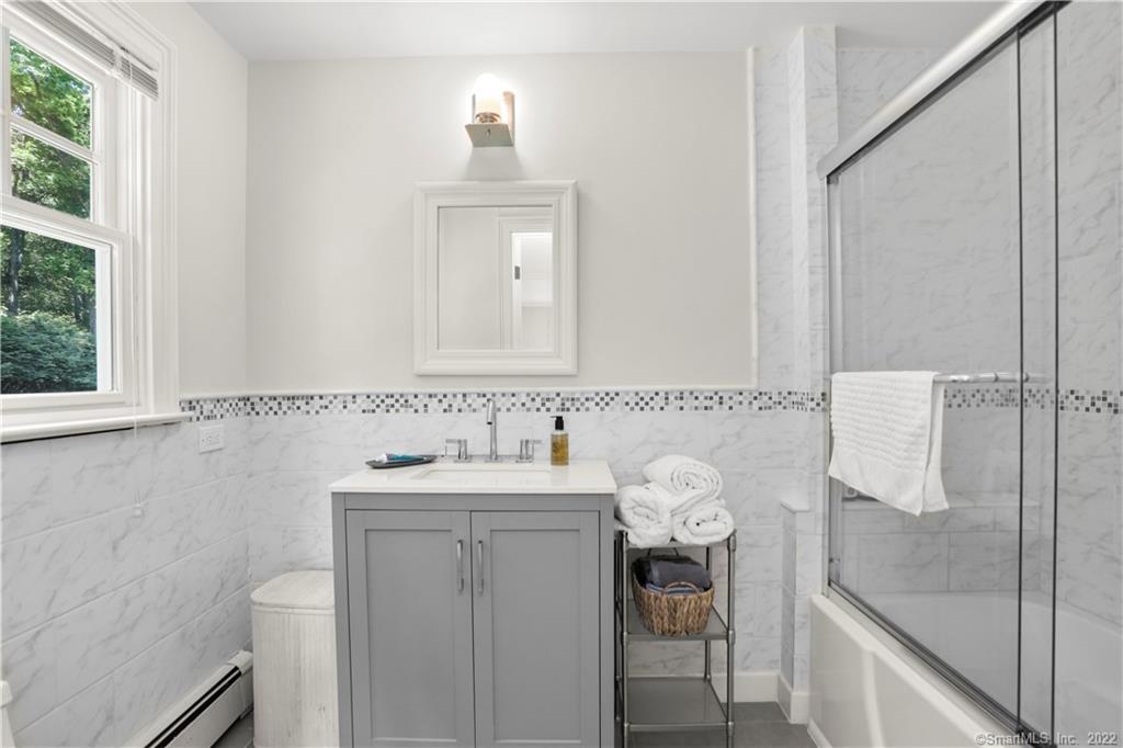 220 Burr Street Fairfield, CT 06824 - Photo 23 of 34 a bathroom with a sink and a mirror