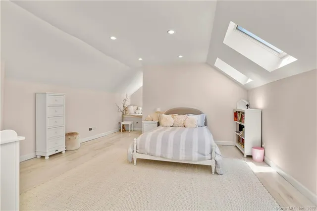 a bedroom with a bed and a lamp