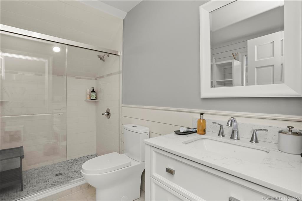 220 Burr Street Fairfield, CT 06824 - Photo 26 of 34 a bathroom with a sink toilet and shower