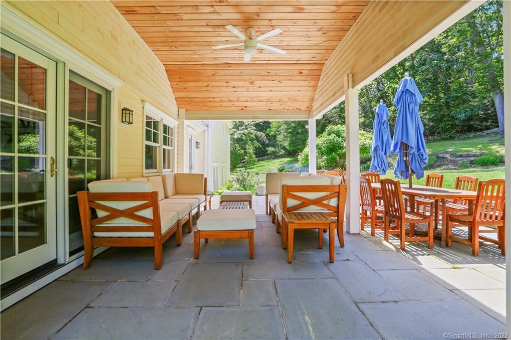 220 Burr Street Fairfield, CT 06824 - Photo 27 of 34 a backyard of a house with barbeque oven table and chairs