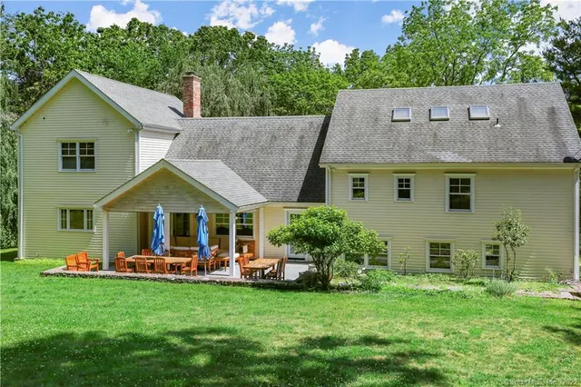 a backyard of a house with table and chairs