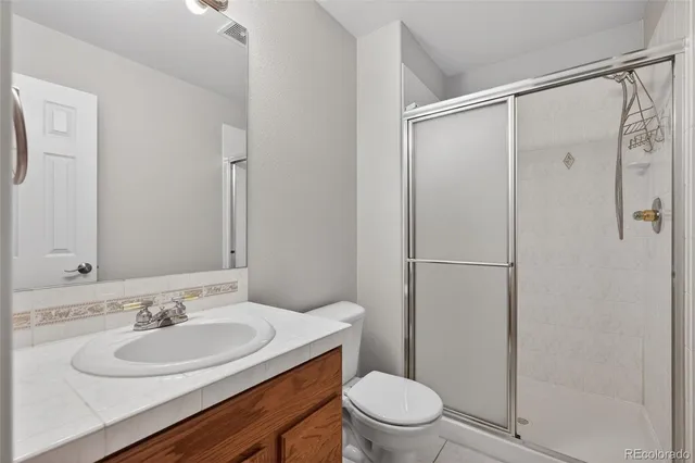 a front view of a house with patio and garden