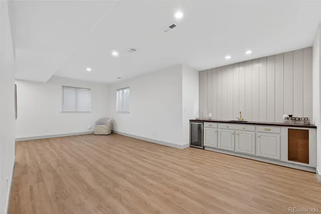 a front view of a house with a garden and garage