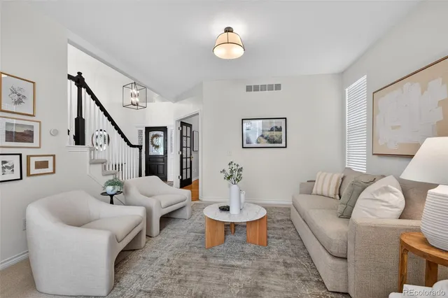 a living room with furniture a fireplace and a large window