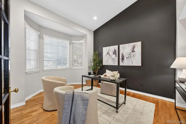 a living room with furniture and floor to ceiling windows