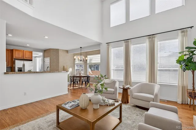 a view of a dining room with furniture a chandelier and wooden floor