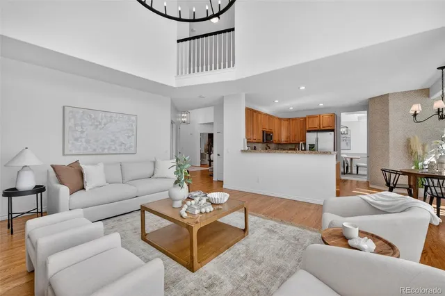 a kitchen with stainless steel appliances granite countertop wooden cabinets a stove a sink a dining table and chairs