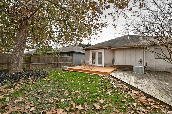 a backyard of a house with table and chairs