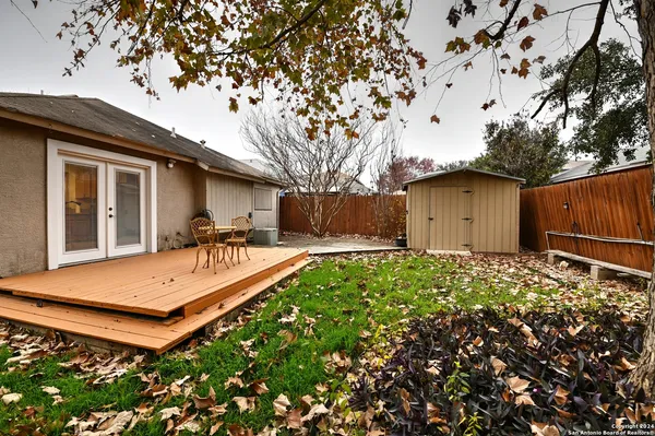 a view of an house with backyard space and balcony