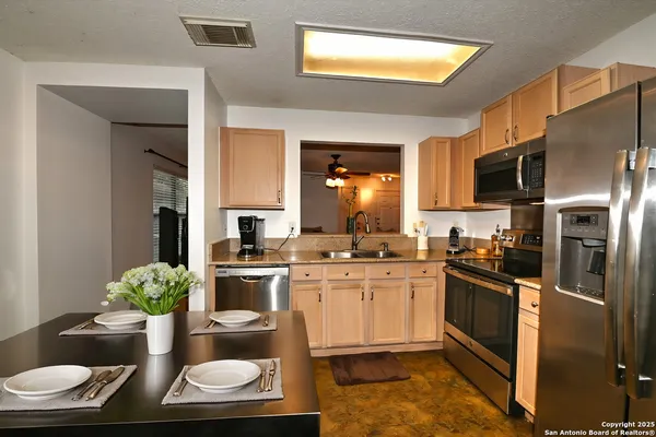 a kitchen with a sink and stainless steel appliances