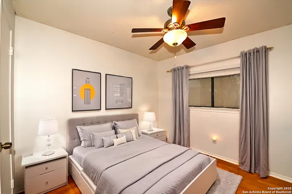 a bedroom with a bed and a chandelier