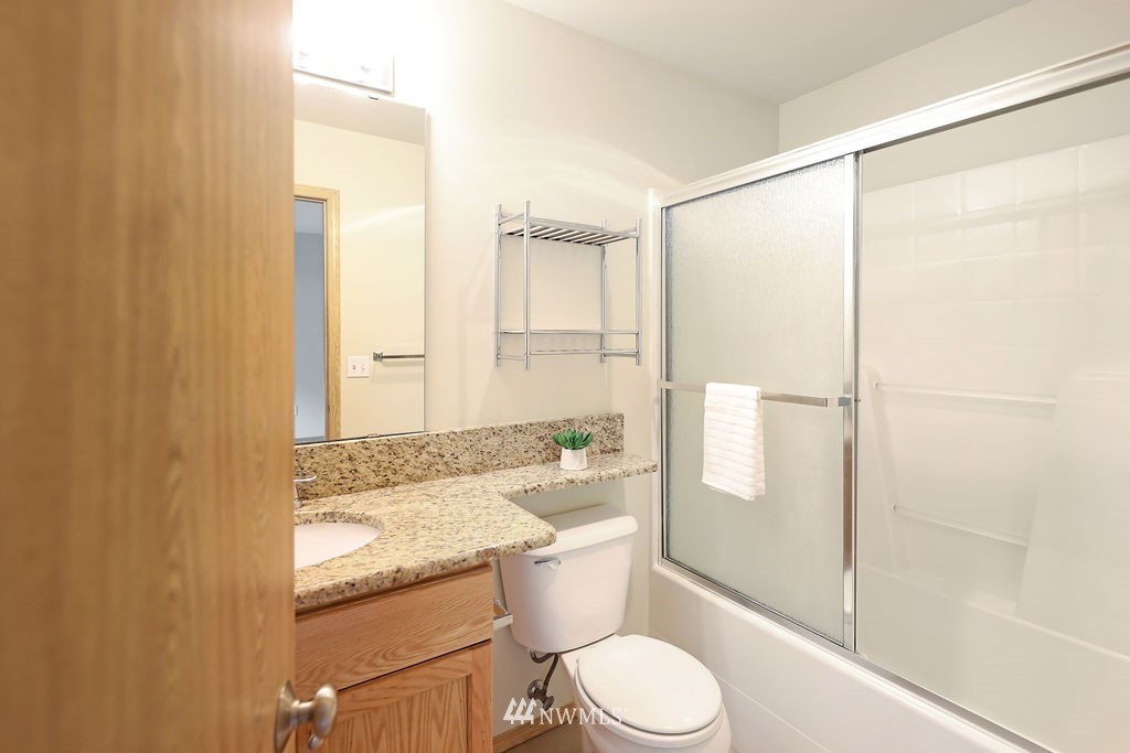 2516 194th Street Southeast Bothell, WA 98012 - Photo 22 of 28 a bathroom with a granite countertop sink toilet and shower