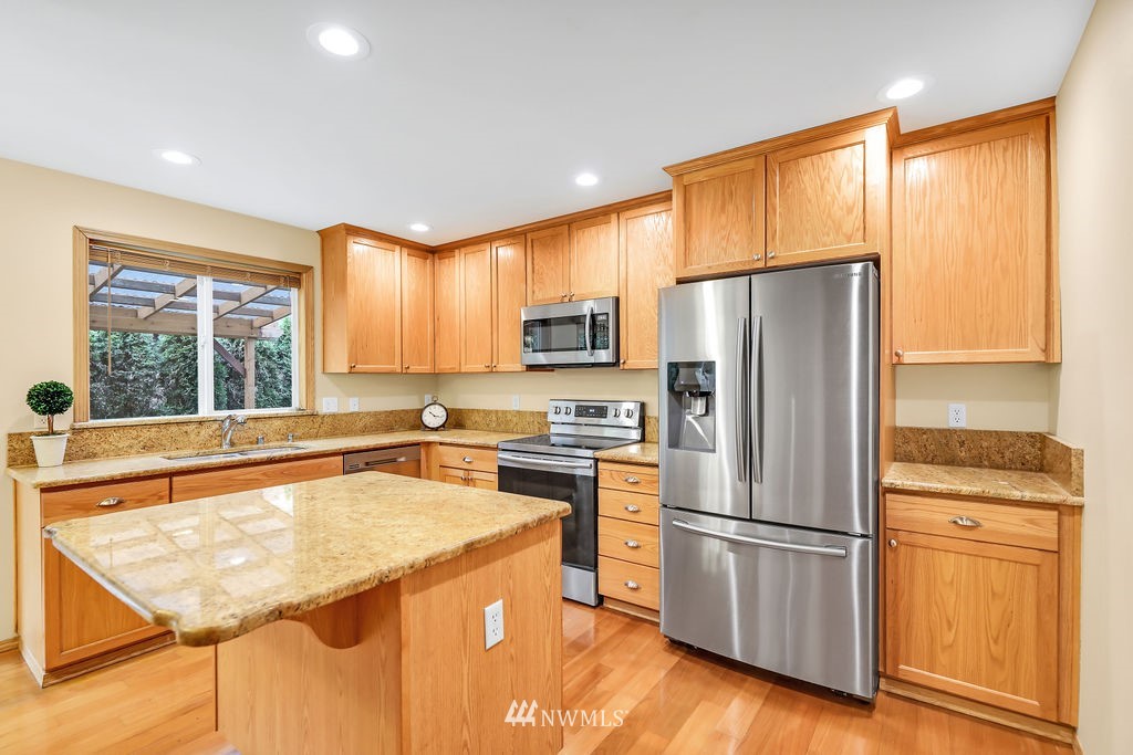 2516 194th Street Southeast Bothell, WA 98012 - Photo 9 of 28 a kitchen with a refrigerator a stove and a sink