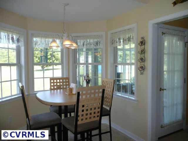 1611 Arrow Road Powhatan, VA 23139 - Photo 7 of 10 Other - You will spend all of your time out here! Well Built Melani Brothers Three Season Sunroom with Vaulted Ceiling, Walls of Windows, Carpet and a Tile Walkway.