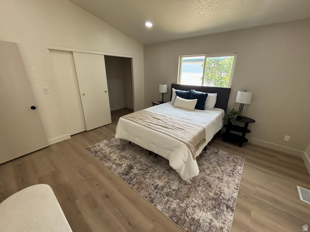 11313 South 265 East Sandy, UT 84070 - Photo 7 of 21 Room featuring vaulted ceilings, wood-finish flooring, and light-toned walls