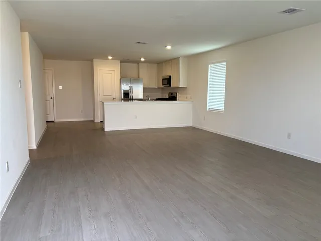 a view of hallway with wooden floor