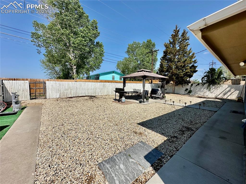 1701 Jerry Murphy Road Pueblo, CO 81001 - Photo 16 of 20 Fenced backyard featuring a gazebo and a patio area