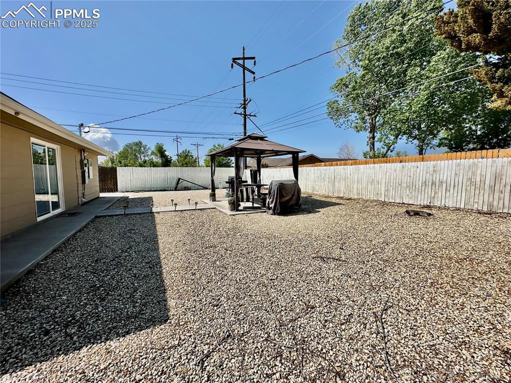 1701 Jerry Murphy Road Pueblo, CO 81001 - Photo 19 of 20 Fenced backyard with a gazebo and a patio