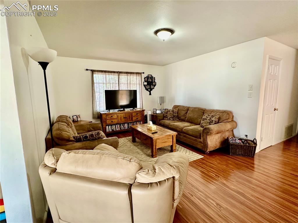 1701 Jerry Murphy Road Pueblo, CO 81001 - Photo 4 of 20 Living area with wood finished floors