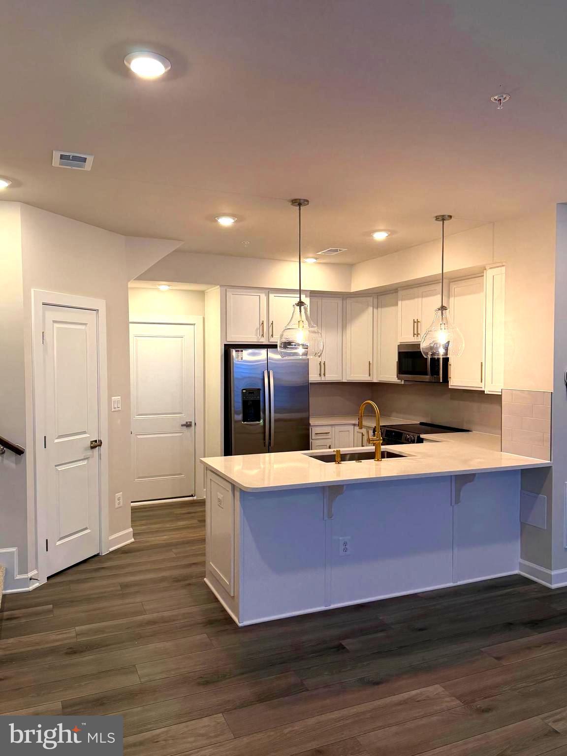 21789 Express Terrace Ashburn, VA 20147 - Photo 2 of 36 a large kitchen with stainless steel appliances granite countertop a sink a refrigerator and a stove