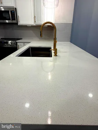 a kitchen with a sink and cabinets