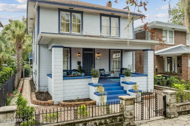 an aerial view of a house with yard swimming pool and lake view