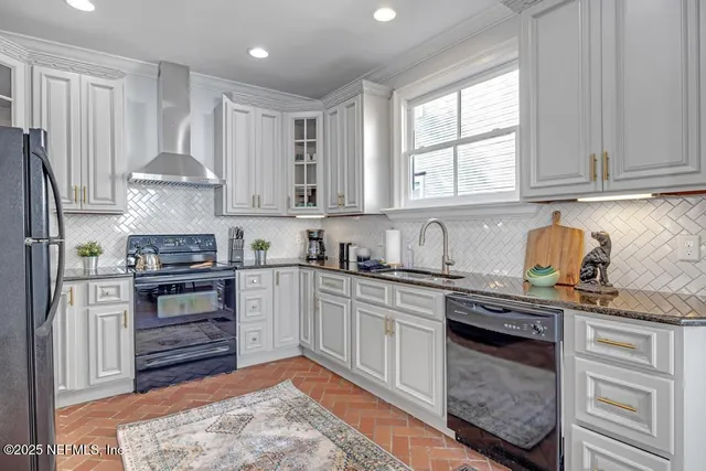 a living room with furniture a window and a chandelier