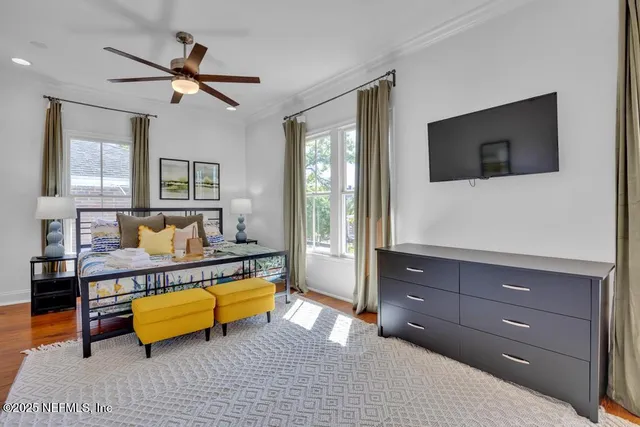 a bedroom with a bed wooden floor and window