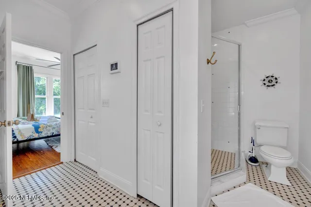 a bathroom with a shower and a mirror