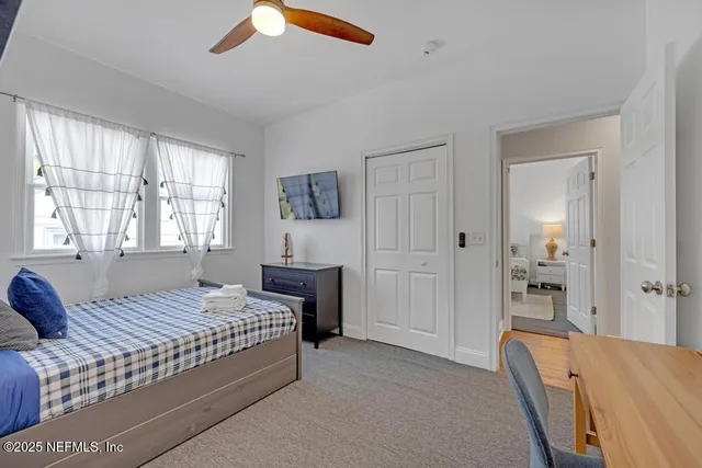 a patio with table and chairs and potted plants
