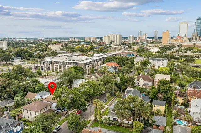 a living room with wooden floor furniture and a potted plant