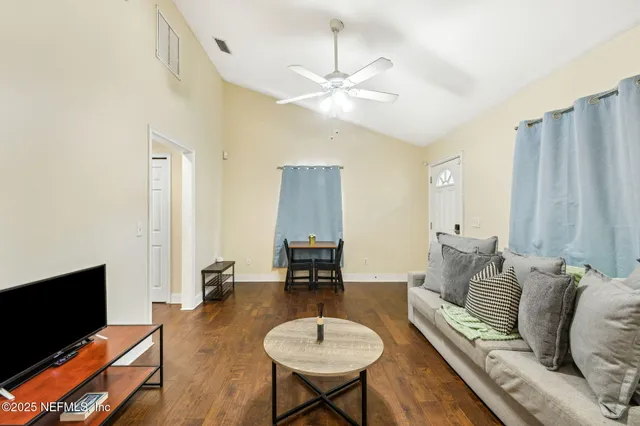 a view of a house with wooden fence