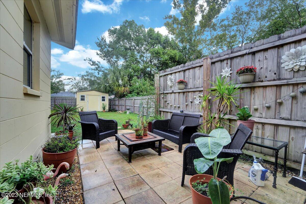 1975 Talladega Road Jacksonville, FL 32209 - Photo 13 of 15 a backyard of a house with barbeque oven table and chairs