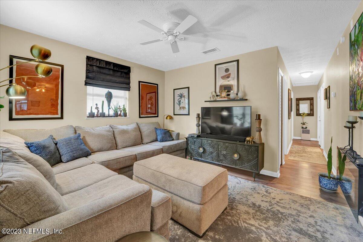 1975 Talladega Road Jacksonville, FL 32209 - Photo 6 of 15 a living room with furniture and a flat screen tv