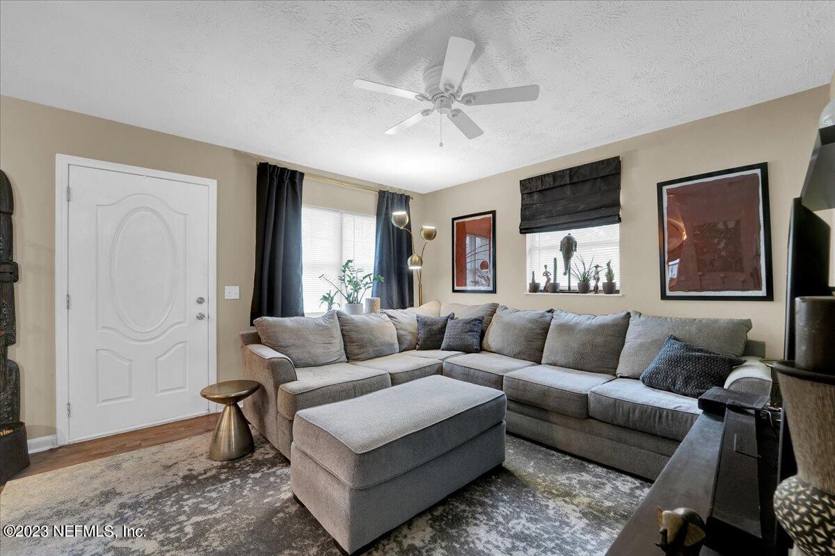 1975 Talladega Road Jacksonville, FL 32209 - Photo 7 of 15 a living room with furniture and a large window