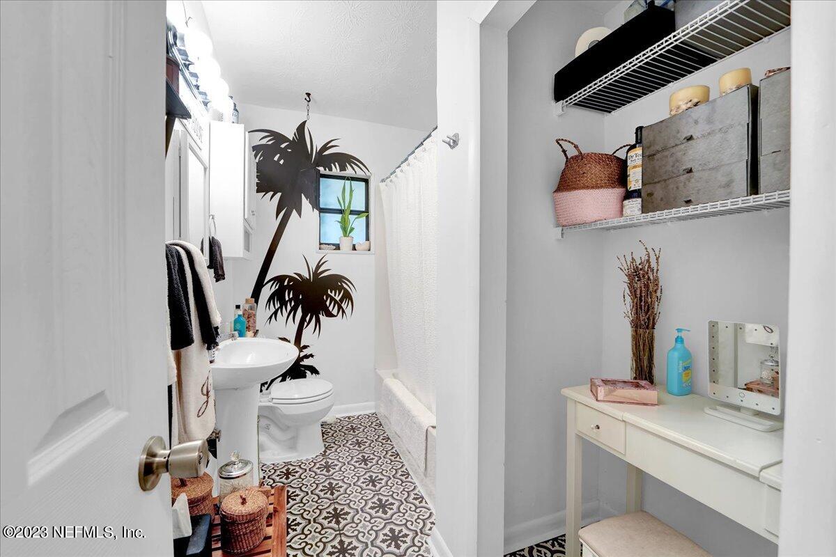 1975 Talladega Road Jacksonville, FL 32209 - Photo 9 of 15 a bathroom with a toilet a sink and a mirror