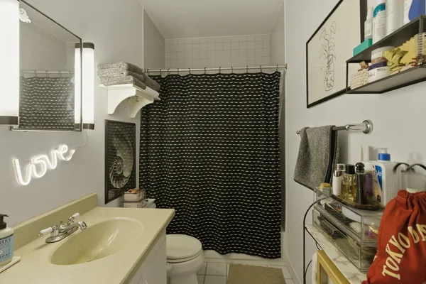 a bathroom with a sink toilet and shower