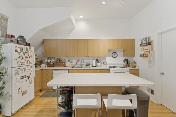 a view of kitchen with cabinets table and chairs