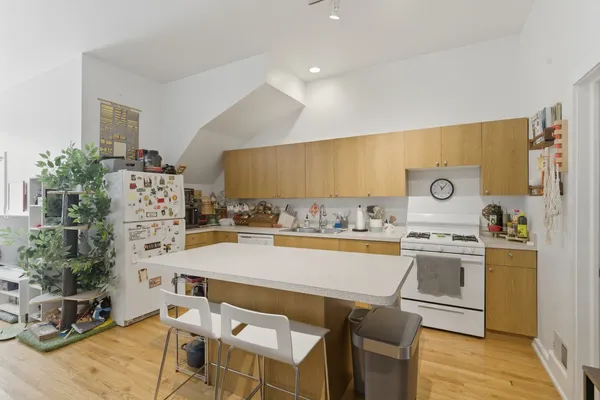 a kitchen with a sink a stove and chairs