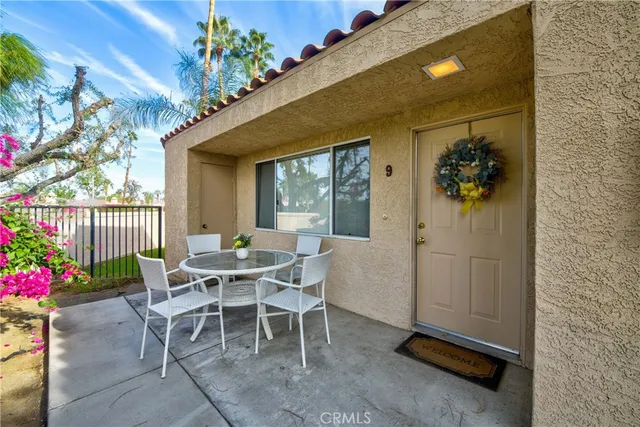 a view of a house with potted plants