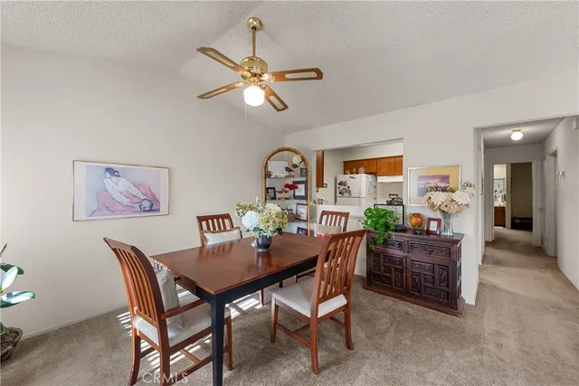 a kitchen with refrigerator and cabinets