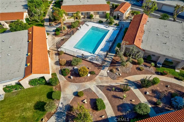 an aerial view of residential houses with outdoor space and street view