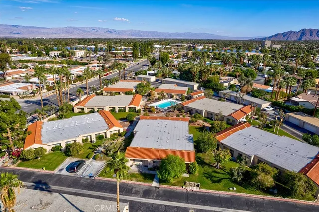 an aerial view of residential houses with outdoor space and street view