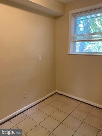 a view of a small space with wooden floor and a window