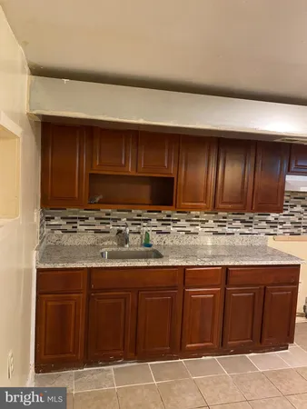 a kitchen with stainless steel appliances granite countertop wooden cabinets and a counter top